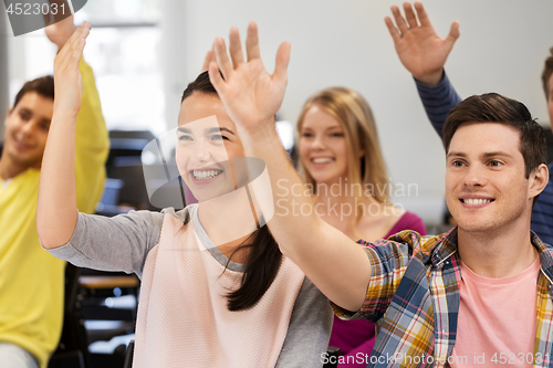 Image of group of smiling students in lecture hall