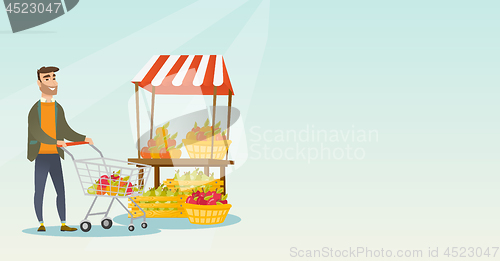 Image of Young caucasian man pushing a supermarket cart.