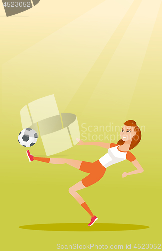 Image of Young caucasian soccer player kicking a ball.