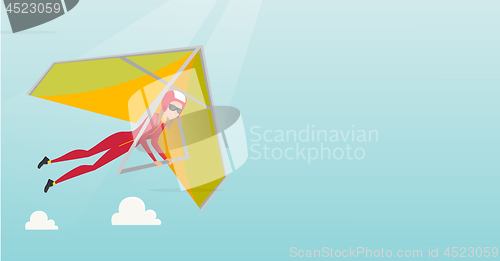 Image of Young caucasian woman flying on hang-glider.