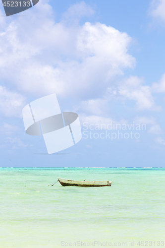 Image of Fishing boat on picture perfect white sandy beach with turquoise blue sea, Paje, Zanzibar, Tanzania.