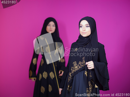 Image of two hijab muslim woman on pink background