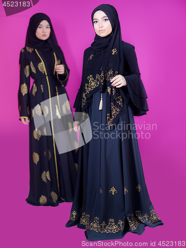 Image of two hijab muslim woman on pink background