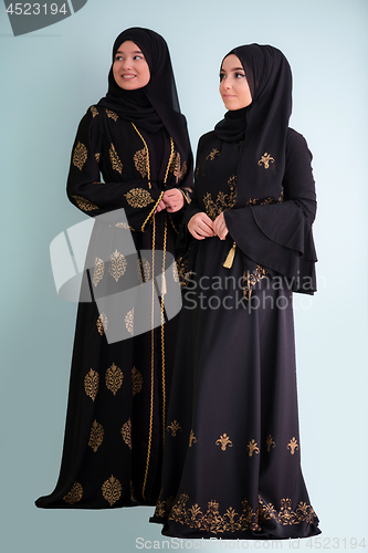 Image of two hijab muslim woman on cyan background