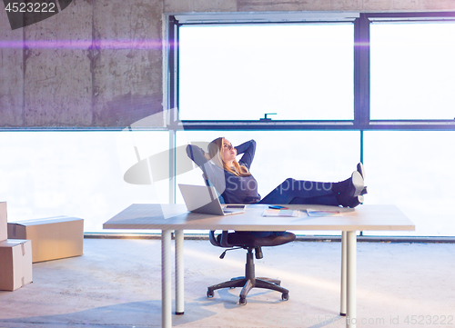Image of young female architect taking a break on construction site