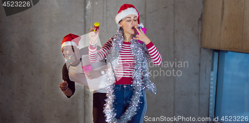 Image of multiethnic business couple celebrating new year party