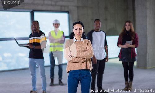 Image of young businesswoman on construction site