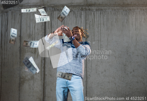 Image of black businessman making the rain of money