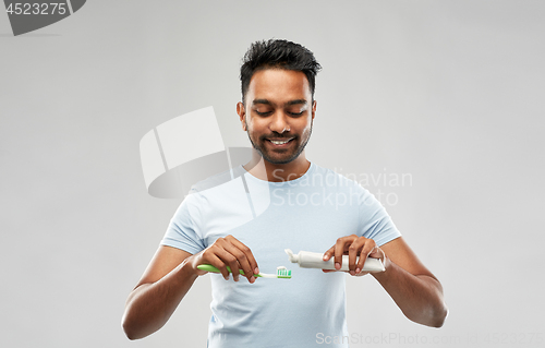 Image of indian man with toothbrush and toothpaste