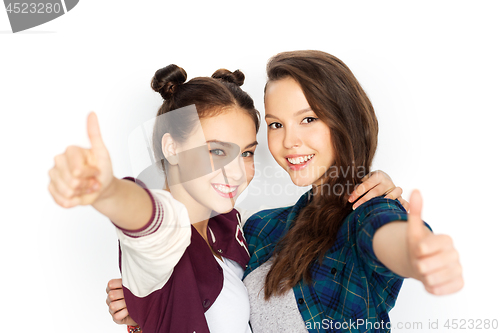 Image of happy teenage girls hugging and showing thumbs up