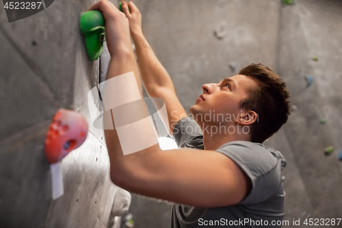 Image of young man exercising at indoor climbing gym