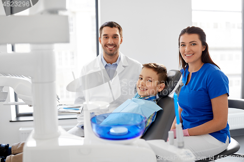 Image of dentists and kid patient at dental clinic