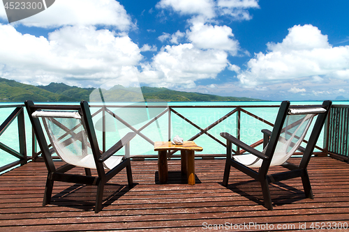 Image of two chaise longues on terrace in french polynesia