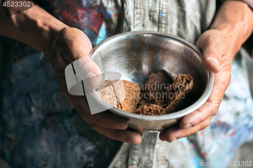 Image of Male beggar hands seeking food or money at public path way