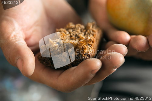 Image of Male beggar hands seeking food or money at public path way