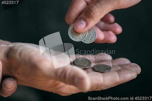 Image of Male beggar hands seeking money on the wooden floor at public path way