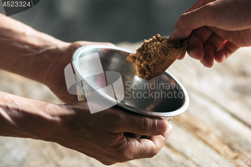 Image of Male beggar hands seeking food or money at public path way