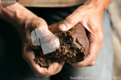 Image of Male beggar hands seeking food or money at public path way