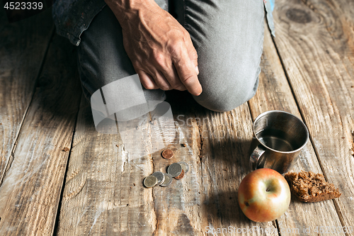 Image of Male beggar hands seeking food or money at public path way