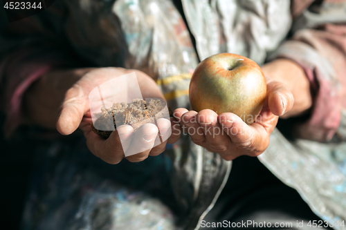 Image of Male beggar hands seeking food or money at public path way