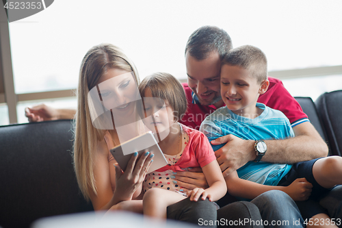 Image of happy young couple spending time with kids