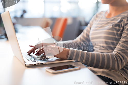 Image of businesswoman using a laptop in startup office