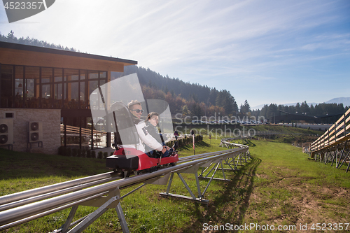 Image of couple enjoys driving on alpine coaster