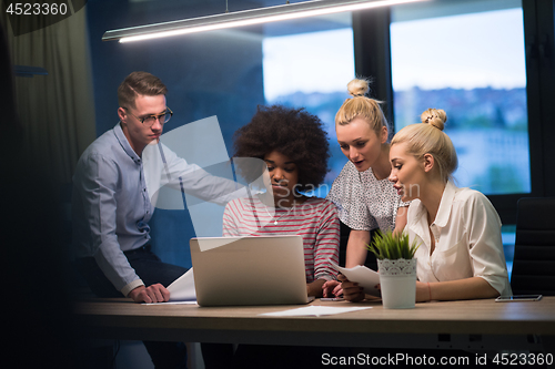 Image of Multiethnic startup business team in night office