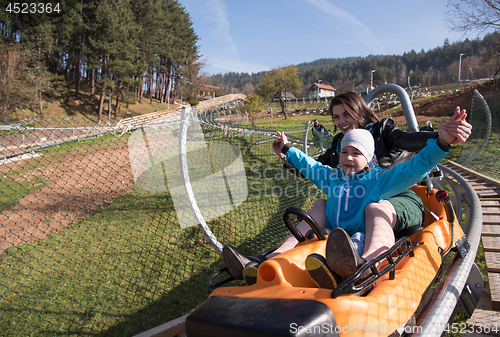 Image of mother and son enjoys driving on alpine coaster