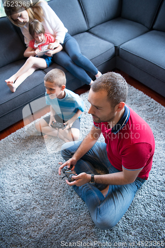 Image of Happy family playing a video game