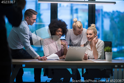 Image of Multiethnic startup business team in night office