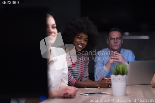 Image of Multiethnic startup business team in night office