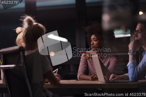 Image of Multiethnic startup business team in night office