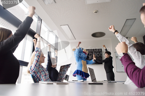 Image of boss dresed as bear having fun with business people in trendy of