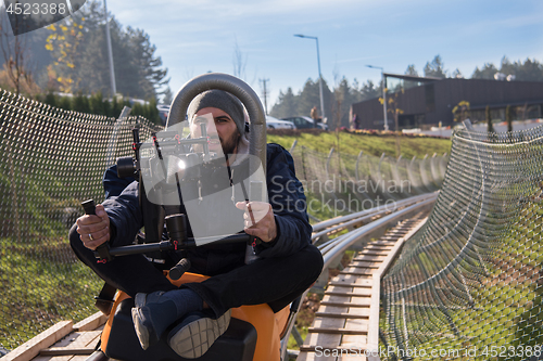 Image of videographer at work on alpine coaster