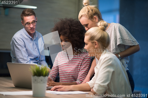 Image of Multiethnic startup business team in night office