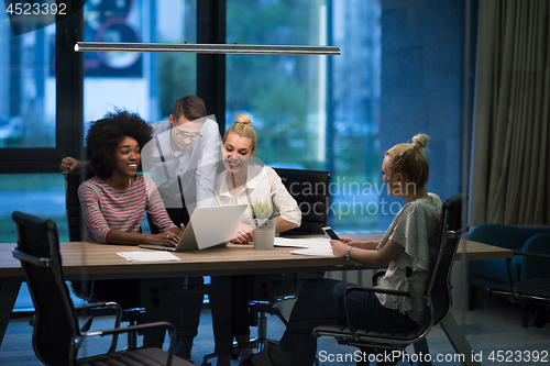 Image of Multiethnic startup business team in night office