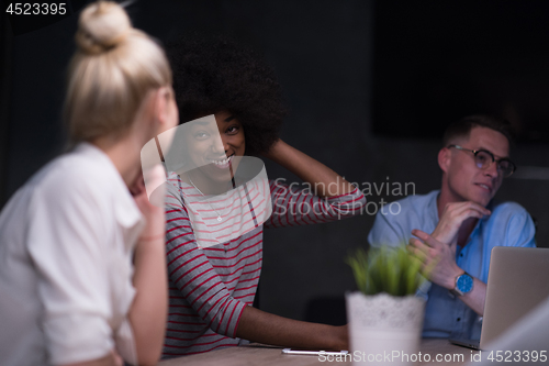 Image of Multiethnic startup business team in night office