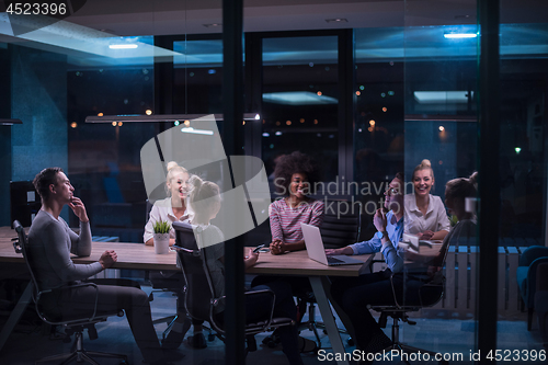 Image of Multiethnic startup business team in night office