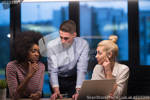 Image of Multiethnic startup business team in night office