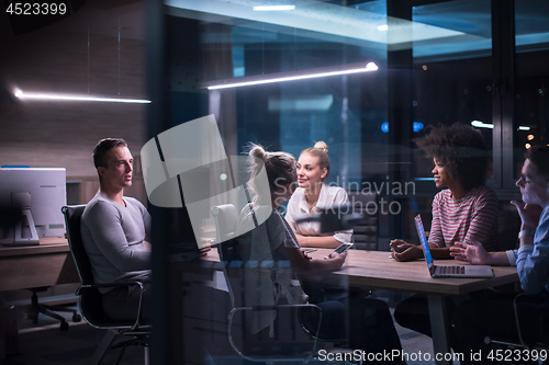 Image of Multiethnic startup business team in night office