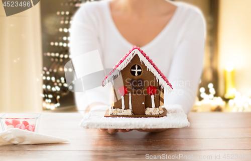 Image of close up of woman with christmas gingerbread house