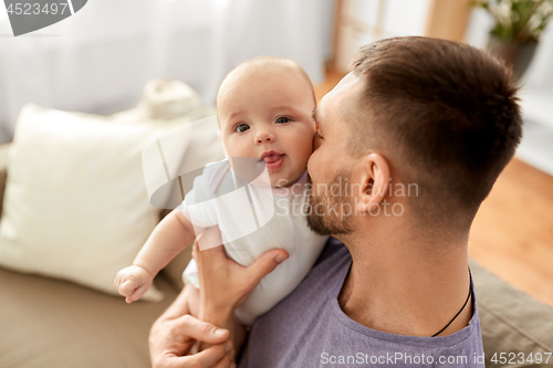 Image of close up of father with little baby girl at home