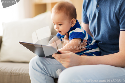 Image of baby and father with tablet pc at home