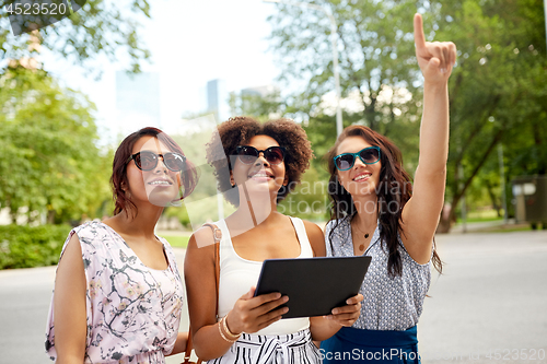 Image of women with tablet pc on street in summer