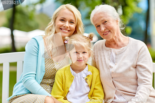 Image of woman with daughter and senior mother at park