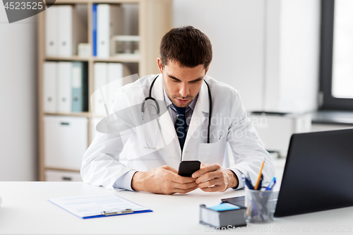 Image of doctor with smartphone at medical office in clinic