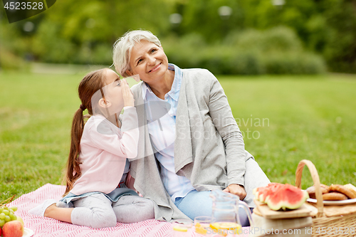 Image of grandmother and granddaughter at picnic in park