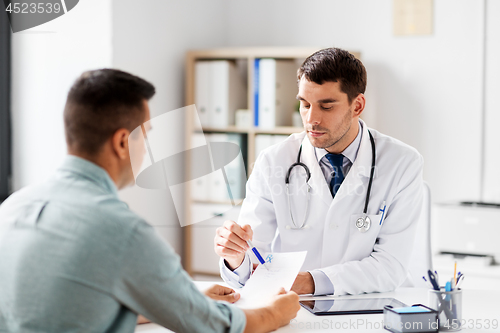 Image of doctor showing prescription to patient at hospital