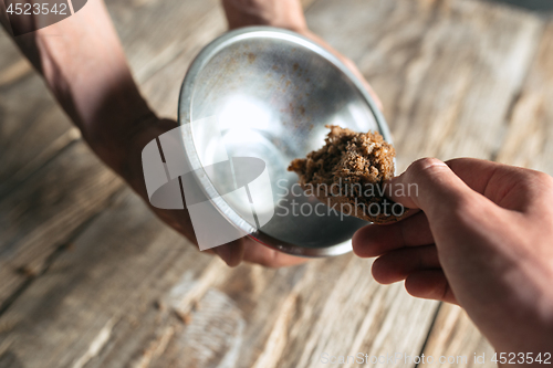 Image of Male beggar hands seeking food or money at public path way